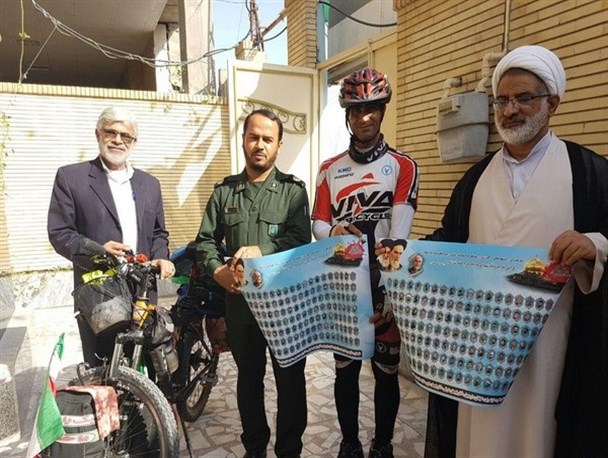 دوچرخه‌سوار ایرانگرد در پاسداشت شهدای مدافع حرم وارد کنگان شد+تصویر